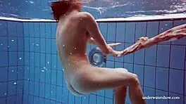 i'm martina, gorgeous redhead teen with big tits swimming in outdoor shower. horny and smoking underwater, tits showing.