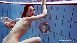 i'm martina, gorgeous redhead teen with big tits swimming in outdoor shower. horny and smoking underwater, tits showing.