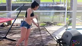 Cute white teen strokes her friend's long black cock in jean shorts outdoors for fun.