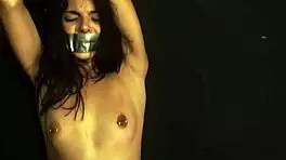 petite tattooed girl ties herself on bed