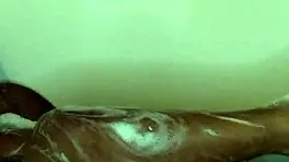 Young ebony babe enjoys a relaxing bath time massage with sensual touches.