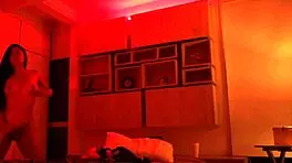 Linda Houston dances seductively under the full red light, captivating everyone with her moves