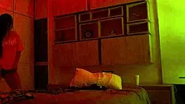 Linda Houston dances seductively under the full red light, captivating everyone with her moves