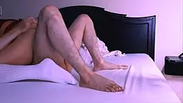 Stepmother and stepson relax on apartment sofa while father is away