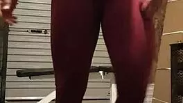 Muscular blonde milf teases in gym, undressing leggings for striptease