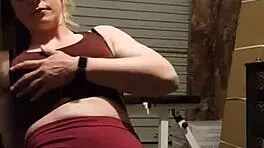 Muscular blonde milf teases in gym, undressing leggings for striptease