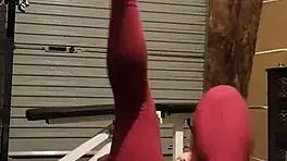 Muscular blonde milf teases in gym, undressing leggings for striptease