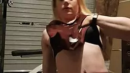 Muscular blonde milf teases in gym, undressing leggings for striptease