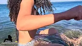 brunette teases boyfriend with beach pissing