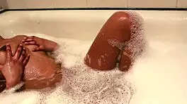 Chill with this teen in the bath as she fingers her hairy pussy.