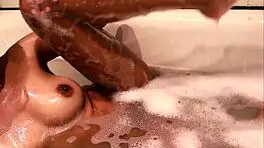 Chill with this teen in the bath as she fingers her hairy pussy.