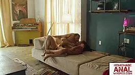 kira noir takes big white cock in her ass on the couch