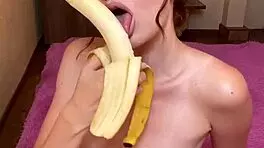 Hot brunette enjoys sucking banana