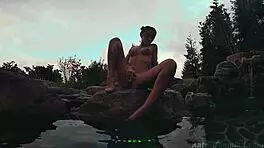 Sexy brunette fingering her pussy outdoors at the resort.