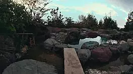 Sexy brunette fingering her pussy outdoors at the resort.