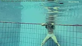 Nastya volna swims gracefully underwater like a wave in the pool