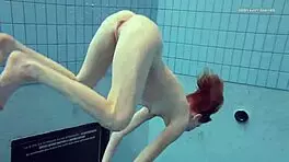 Nastya volna swims gracefully underwater like a wave in the pool