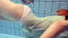 Nastya volna swims gracefully underwater like a wave in the pool