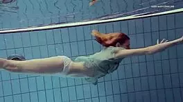 Nastya volna swims gracefully underwater like a wave in the pool