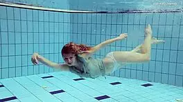Nastya volna swims gracefully underwater like a wave in the pool