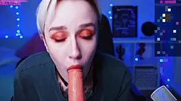 in a homemade video, a tattooed blonde teen with short hair and small tits sucks on a dildo solo