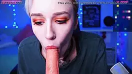 in a homemade video, a tattooed blonde teen with short hair and small tits sucks on a dildo solo