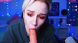 in a homemade video, a tattooed blonde teen with short hair and small tits sucks on a dildo solo