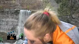 blonde gives outdoor blowjob at waterfall, almost caught