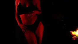 she dances in the dark, slowly removing her panties