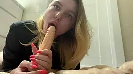 Blonde teen teases with striptease, undresses, and sucks big dildo with big tits and ass