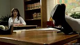 busty milf professor guides student in classroom activity