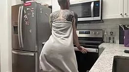 Young 18+ thug with tattoo twerks big ass in kitchen shorts, hairless close-up amateur dancing