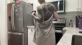 Young 18+ thug with tattoo twerks big ass in kitchen shorts, hairless close-up amateur dancing