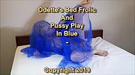 odette frolics on bed playing with pussy in blue