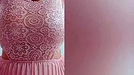 This pretty girl in pink dress plays with her huge natural tits at home!