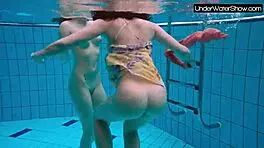 bubarek and birtakik splash and tease each other underwater in the pool, brunette teens in bikinis