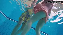 bubarek and birtakik splash and tease each other underwater in the pool, brunette teens in bikinis