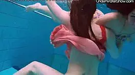 bubarek and birtakik splash and tease each other underwater in the pool, brunette teens in bikinis