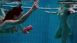bubarek and birtakik splash and tease each other underwater in the pool, brunette teens in bikinis
