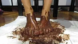 My feet with varnished nails covered in chocolate cream