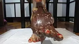 My feet with varnished nails covered in chocolate cream