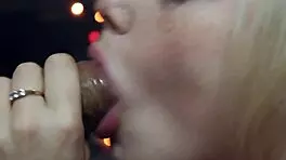 wife gives close-up attention to friend under romantic lights