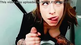 Gorgeous redhead invades men's bathroom for a blowjob