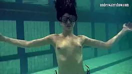 brunette teen kristina andreeva enjoys a naked swim in the pool, showing off her tight body.