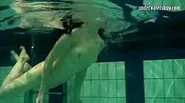 brunette teen kristina andreeva enjoys a naked swim in the pool, showing off her tight body.