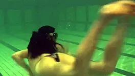 brunette teen kristina andreeva enjoys a naked swim in the pool, showing off her tight body.