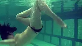 brunette teen kristina andreeva enjoys a naked swim in the pool, showing off her tight body.