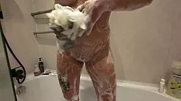A young woman bathing in the shower invites someone to join her for a relaxing time