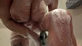 A young woman bathing in the shower invites someone to join her for a relaxing time