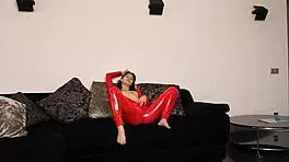 Bold Brunette In Red Latex Shows Off Her Shaved Young Pussy